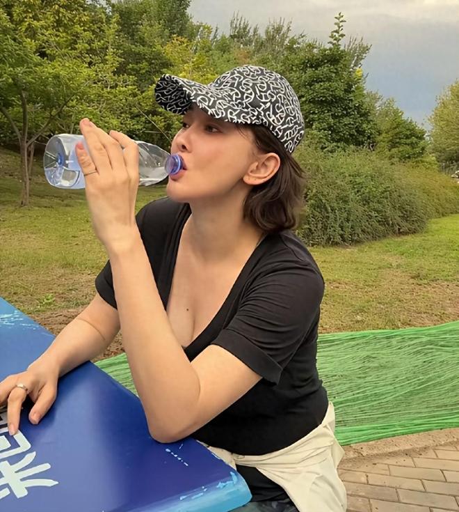 53岁牛莉公园晨练被偶遇大口喝水脸色红润白头发无意间漏出(图1)